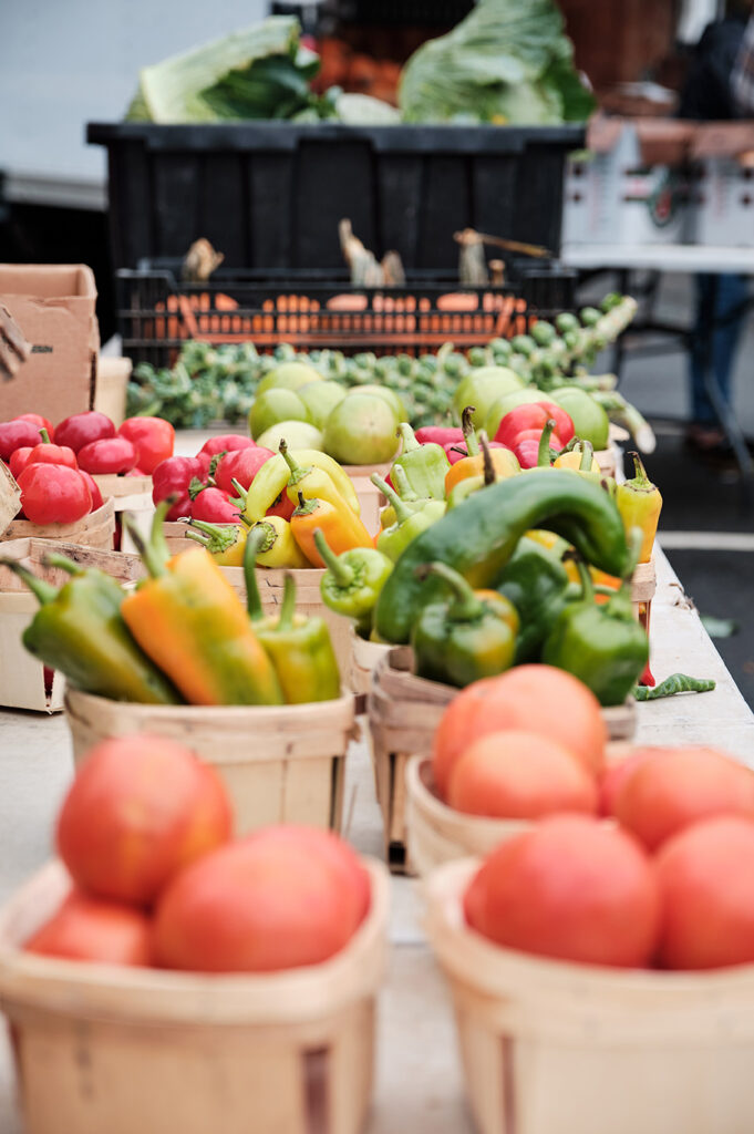 table full of vegetables. tomatoes, peppers, red peppers, green peppers. North End Farmers Market