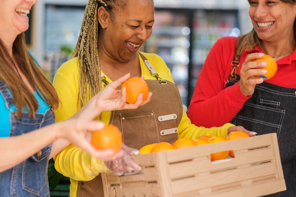 Three middle-aged women having fun in the market